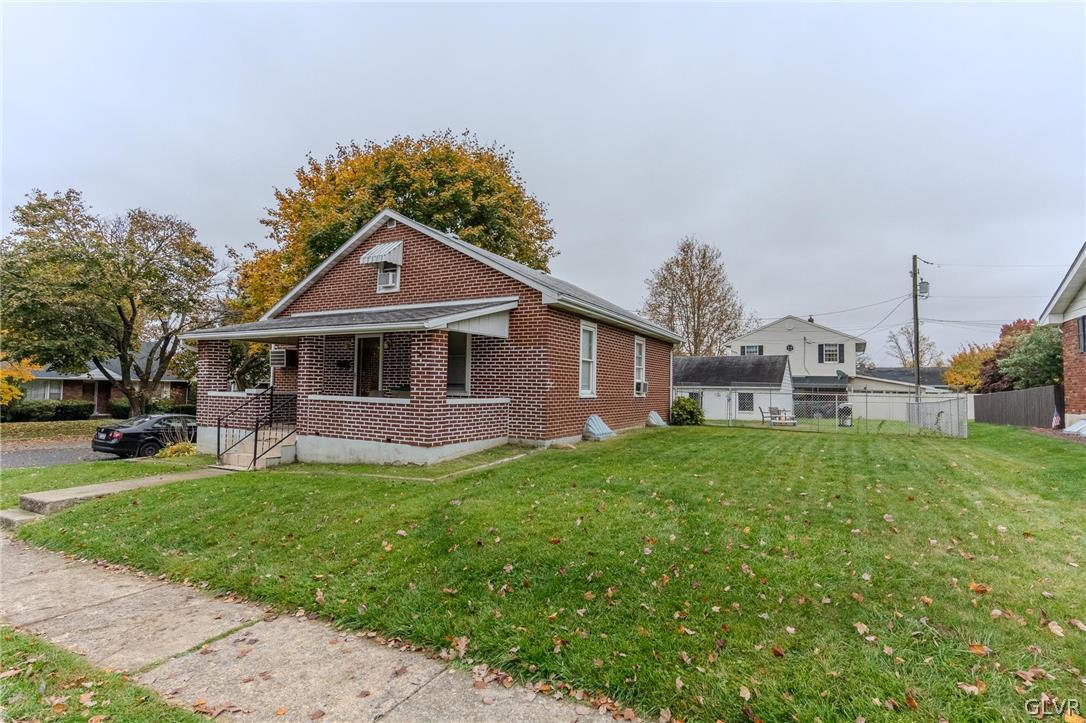 4002 Chew Street Allentown, PA 18104 - Photo 2 of 27 a front view of a house with a garden and yard