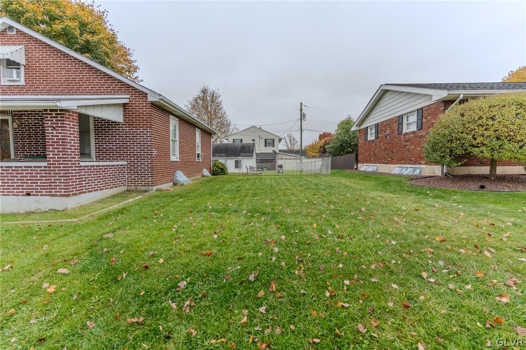 4002 Chew Street Allentown, PA 18104 - Photo 4 of 27 a view of a yard in front of a house with large windows