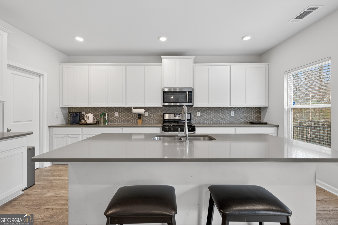 3511 Argent Way Marietta, GA 30008 - Photo 21 of 56 a kitchen with stainless steel appliances granite countertop a stove a sink and a microwave