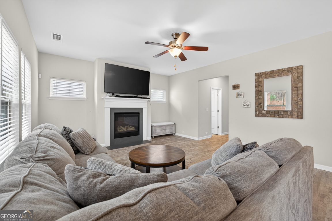 3511 Argent Way Marietta, GA 30008 - Photo 31 of 56 a living room with furniture a flat screen tv and a fireplace