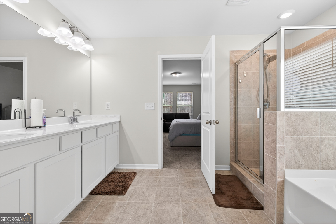 3511 Argent Way Marietta, GA 30008 - Photo 48 of 56 a en suite bathroom with a sink a large mirror and shower