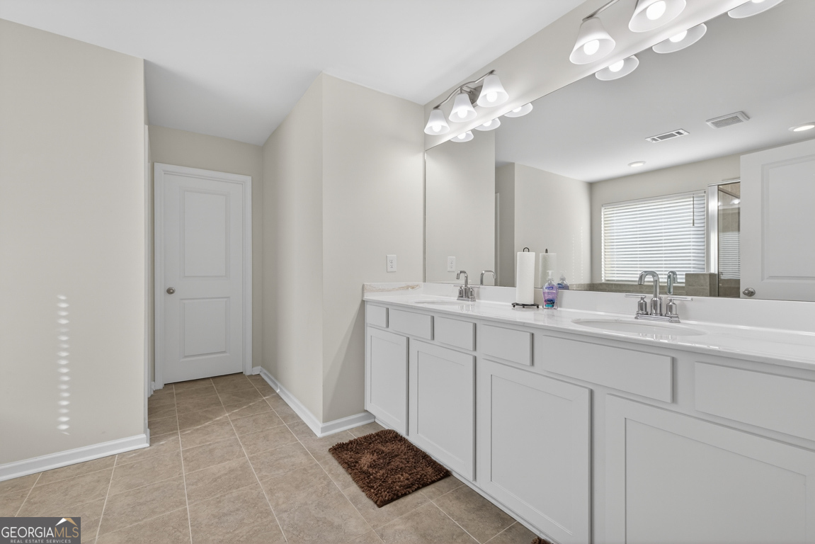 3511 Argent Way Marietta, GA 30008 - Photo 50 of 56 a spacious bathroom with a double vanity sink a mirror and a shower