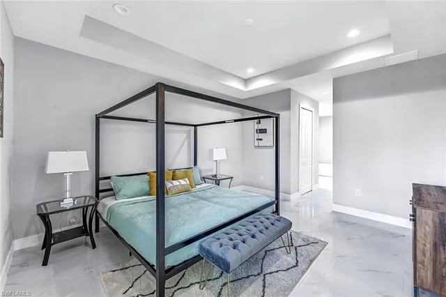 a bedroom with a bed a lamp and a table