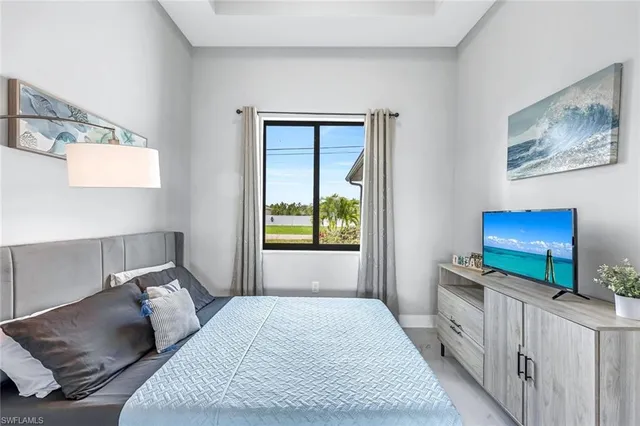 a bedroom with furniture and a flat screen tv