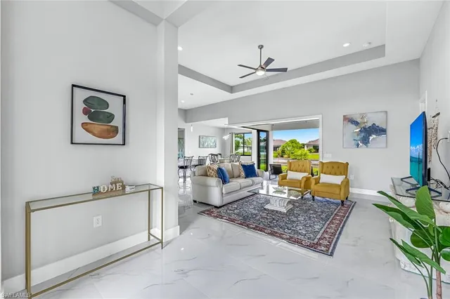 a living room with furniture a rug and a chandelier