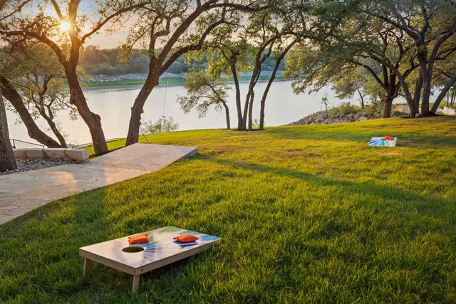 a view of a house with a yard and tree s