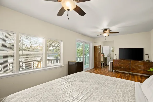 a bathroom with a toilet sink vanity and mirror