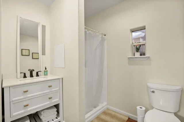 a kitchen with a sink a window and a refrigerator