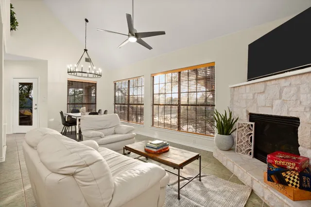 a living room with furniture a fireplace and a flat screen tv