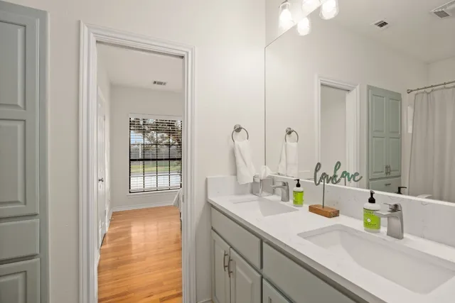 a bathroom with a sink double vanity and a mirror