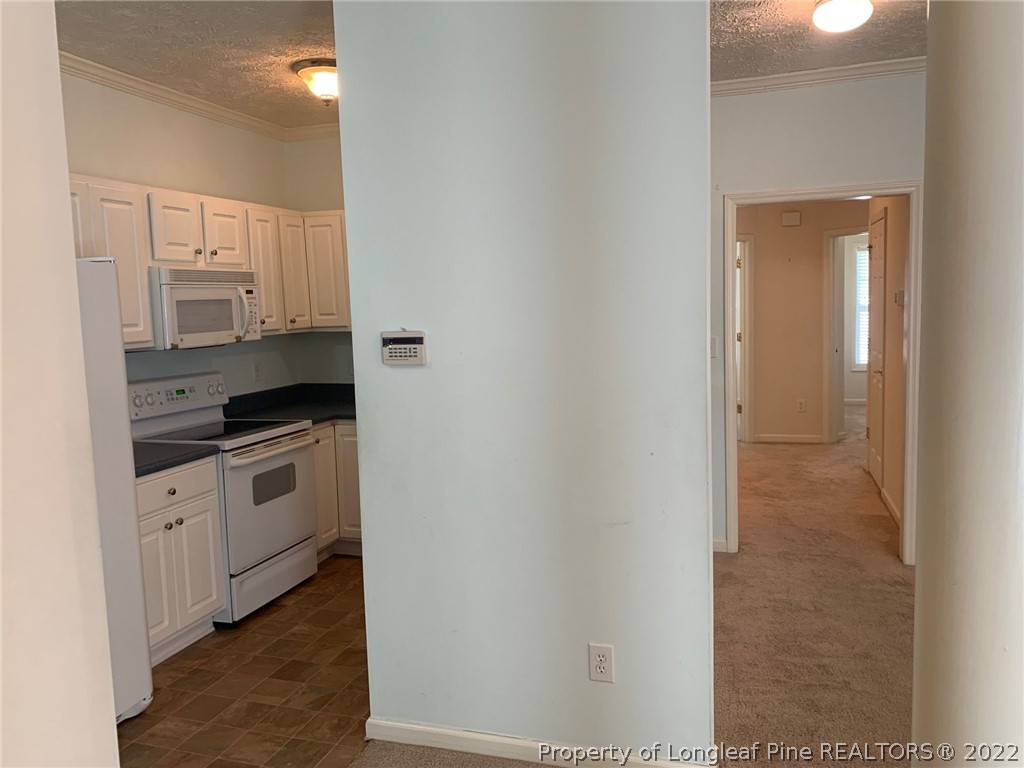 516 Lionshead Road, Unit 6 Fayetteville, NC 28311 - Photo 3 of 24 a kitchen with stainless steel appliances granite countertop a stove and a refrigerator