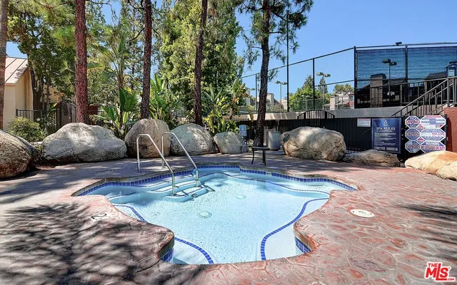 a view of a swimming pool from a lounge chairs