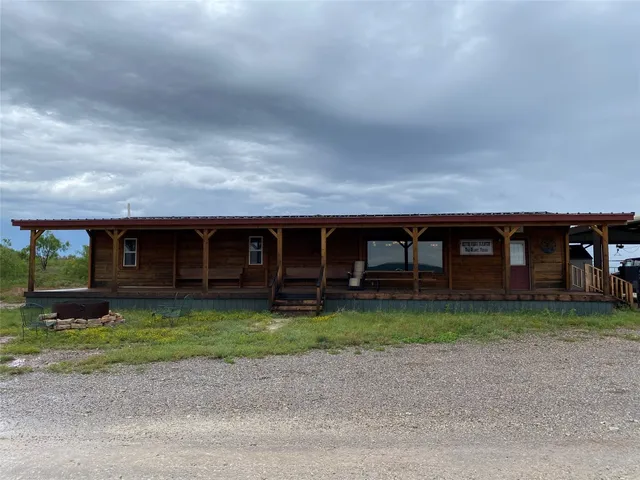 a living room with lots of furniture and kitchen view
