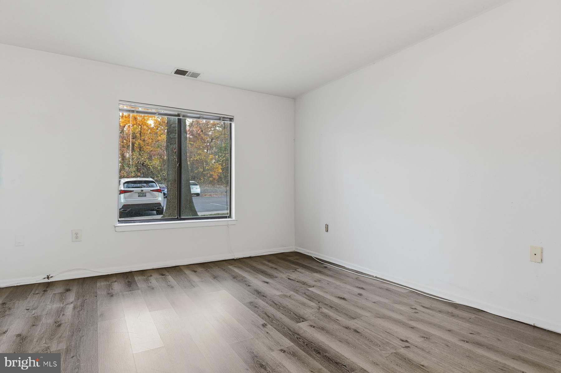 2570 Riva Road, Unit 3C Annapolis, MD 21401 - Photo 11 of 17 an empty room with wooden floor and windows