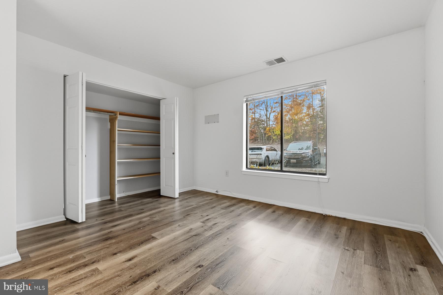 2570 Riva Road, Unit 3C Annapolis, MD 21401 - Photo 13 of 17 a view of an empty room with a window and wooden floor