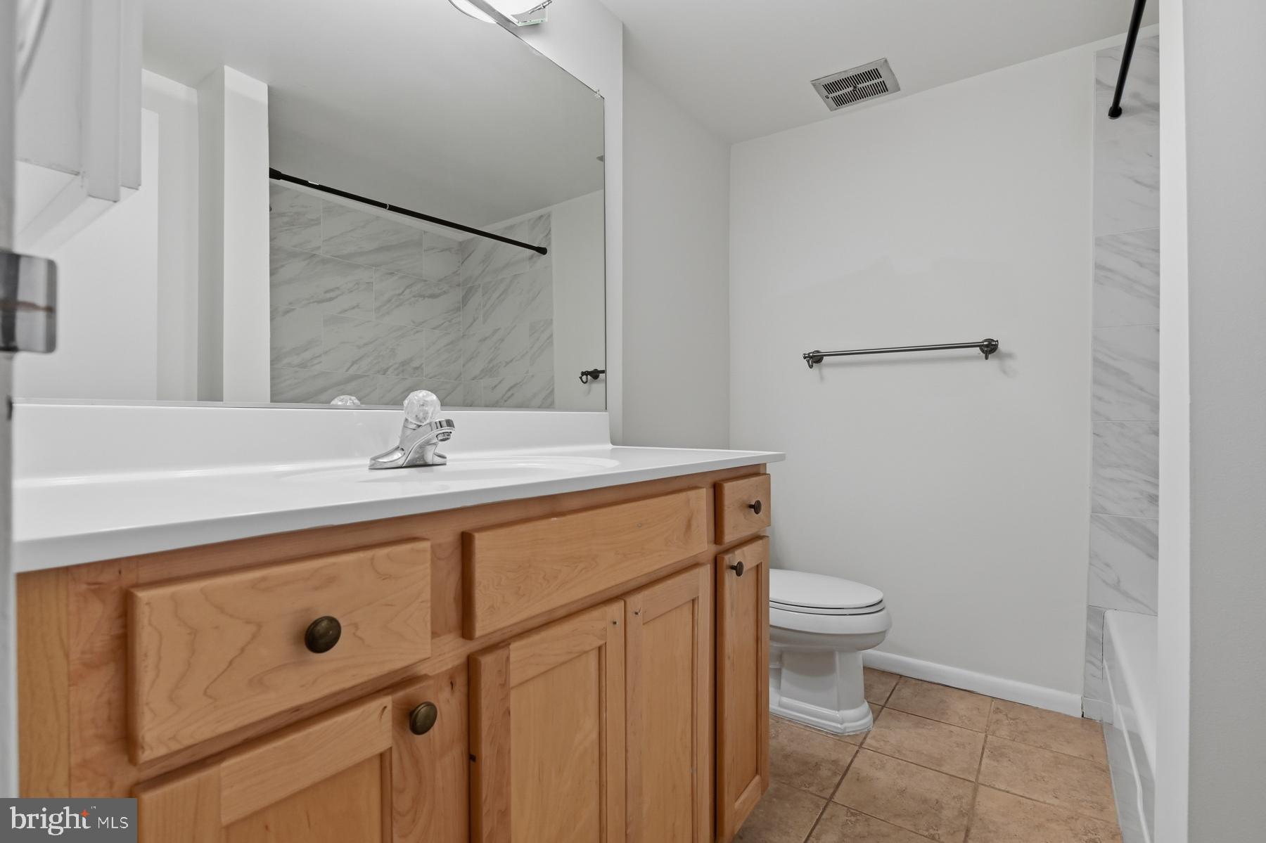 2570 Riva Road, Unit 3C Annapolis, MD 21401 - Photo 15 of 17 a bathroom with a sink mirror vanity and toilet
