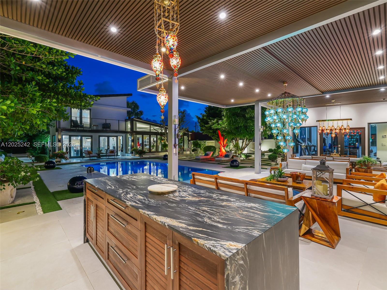 8761 Southwest 56th Street Miami, FL 33165 - Photo 79 of 90 a outdoor kitchen with stainless steel appliances granite countertop a barbecue grill and couches chair with the view