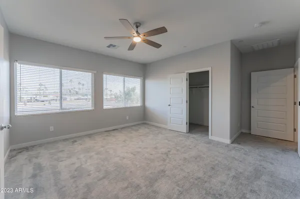 a large kitchen with granite countertop a sink and a wooden floor