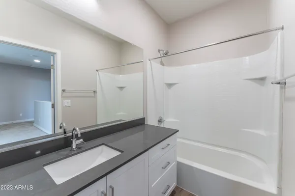 an empty room with closet and windows