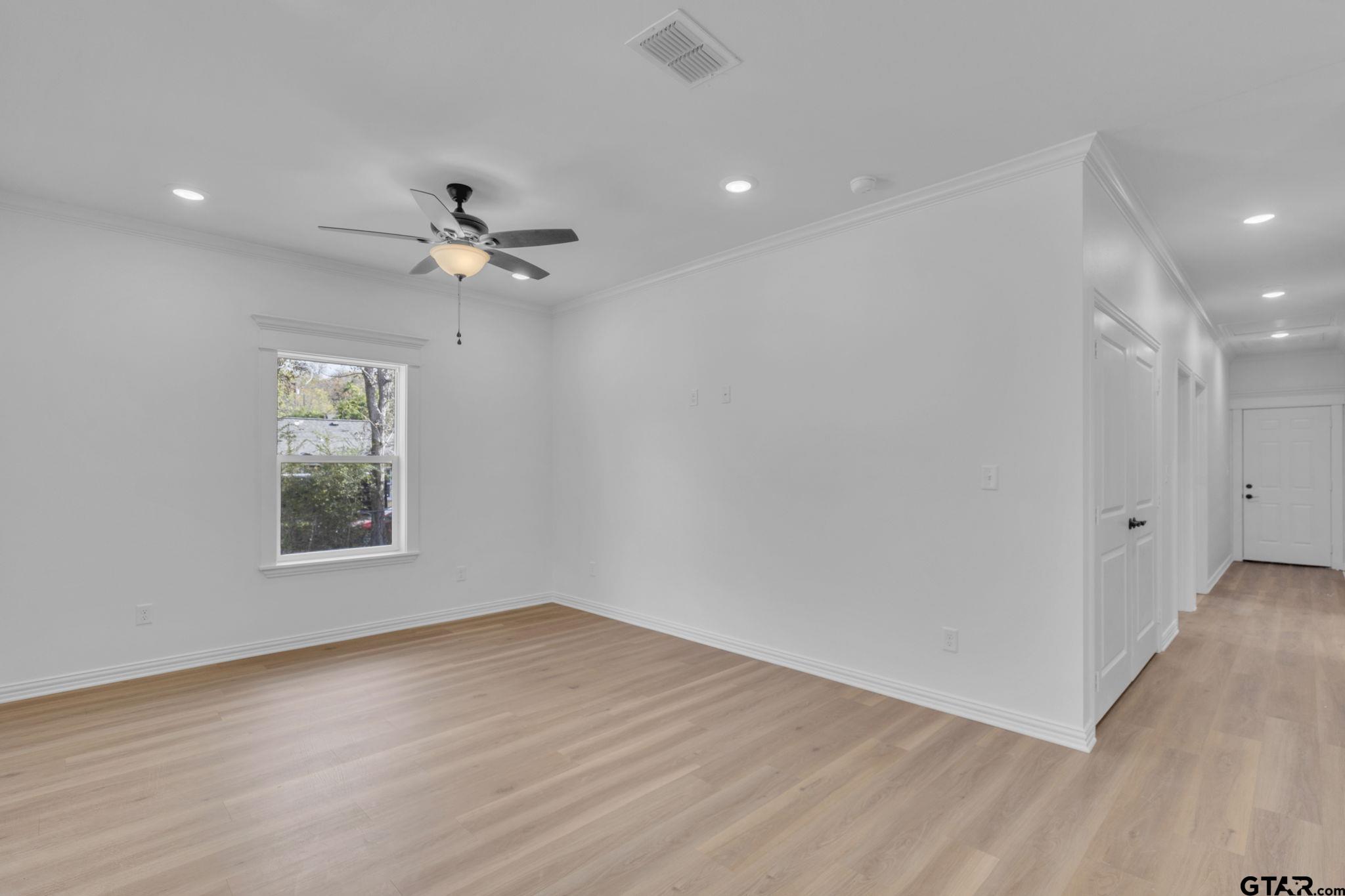 1410 West Connally Street Tyler, TX 75701 - Photo 12 of 29 wooden floor in an empty room with a window
