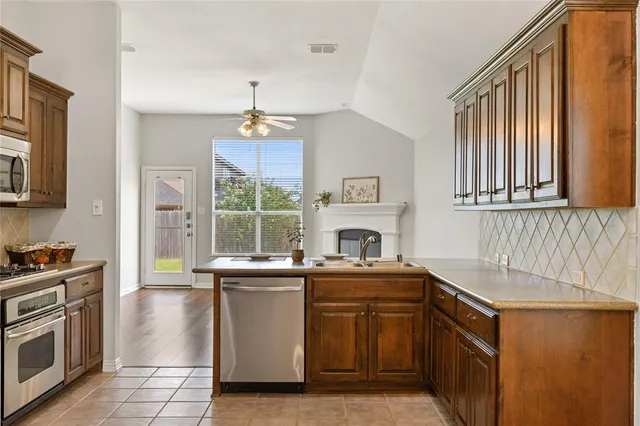 a kitchen with a sink stove and cabinets