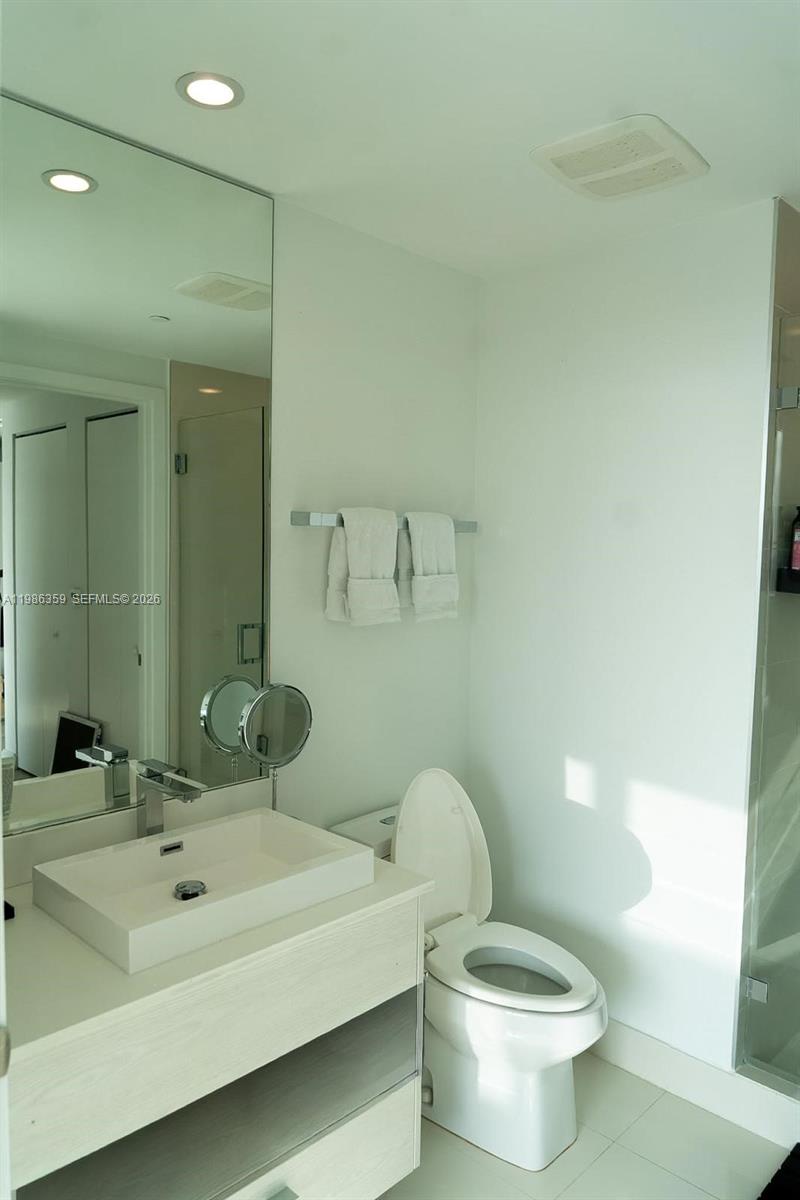 55 Southwest 9th Street, Unit 3607 Miami, FL 33130 - Photo 14 of 15 a bathroom with a sink and a toilet