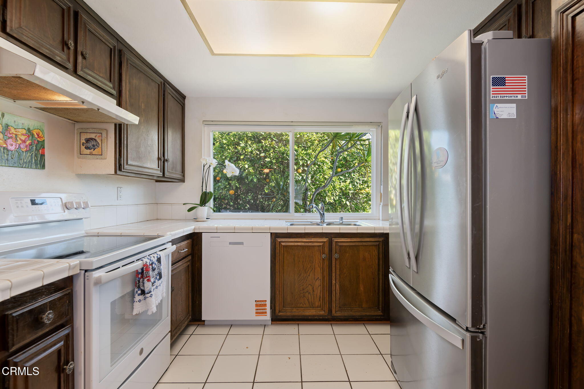 1126 Lawrence Way Oxnard, CA 93035 - Photo 11 of 16 a kitchen with a stove a sink and a refrigerator