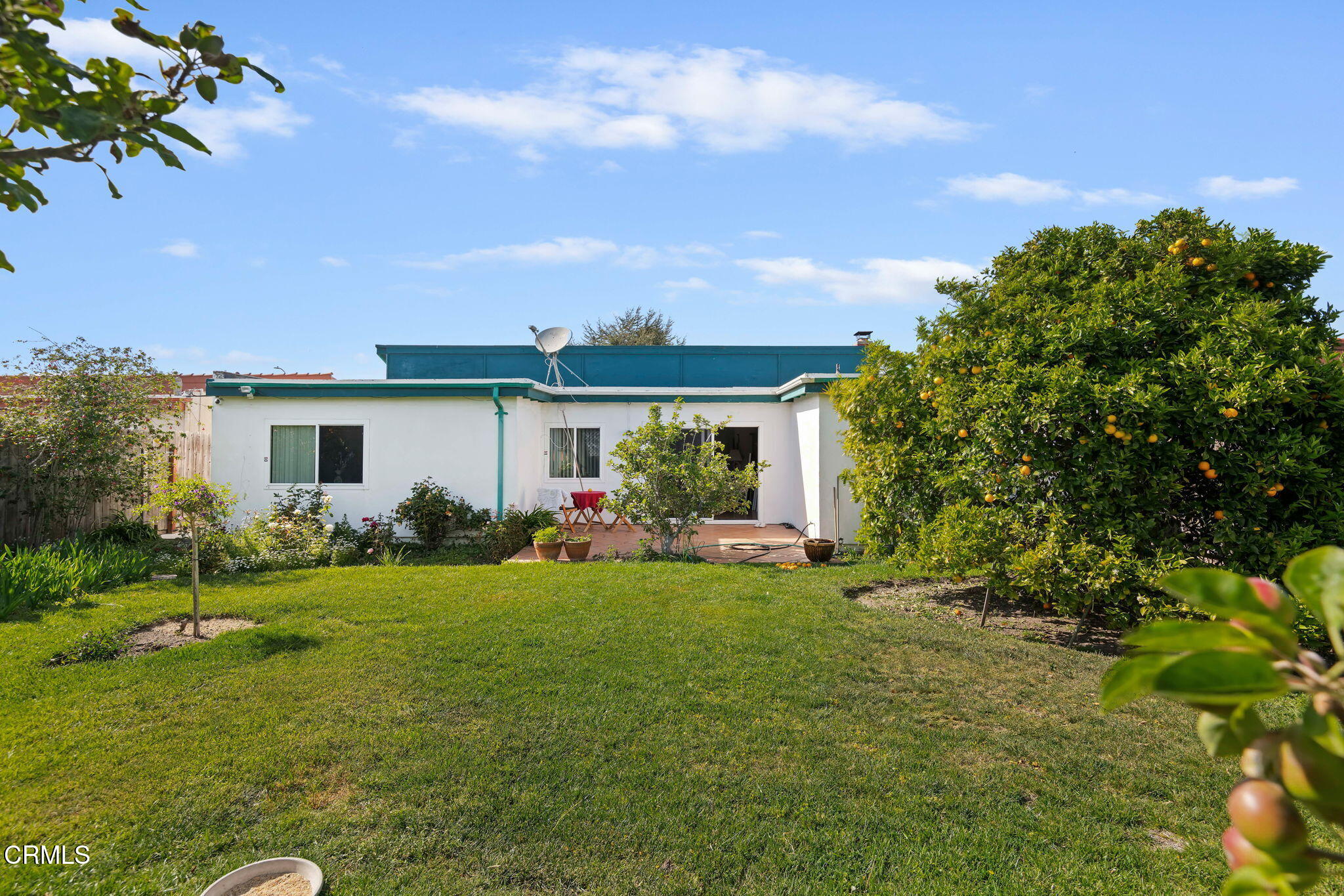 1126 Lawrence Way Oxnard, CA 93035 - Photo 4 of 16 a front view of a house with a garden and porch