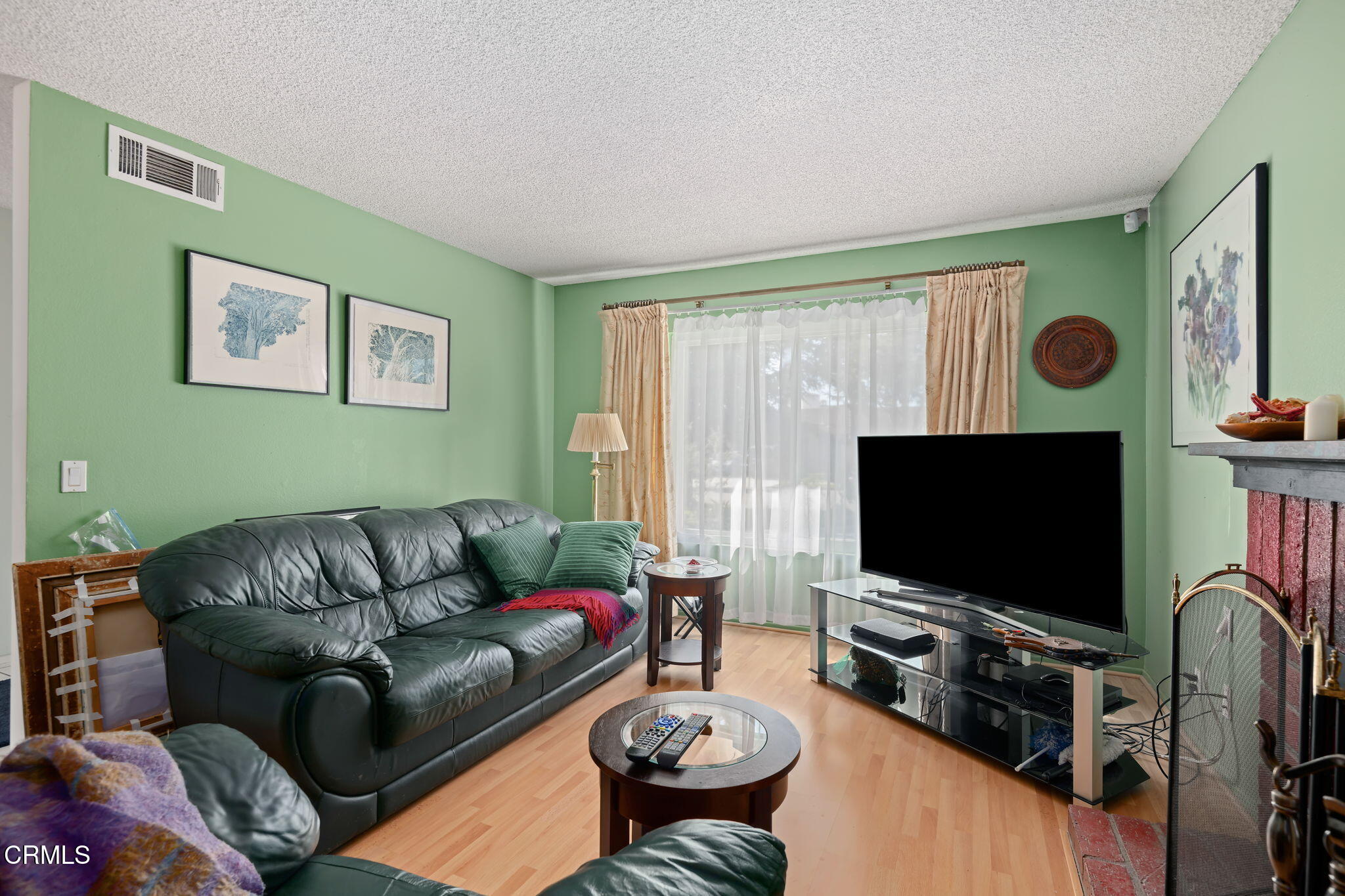 1126 Lawrence Way Oxnard, CA 93035 - Photo 7 of 16 a living room with furniture and a flat screen tv