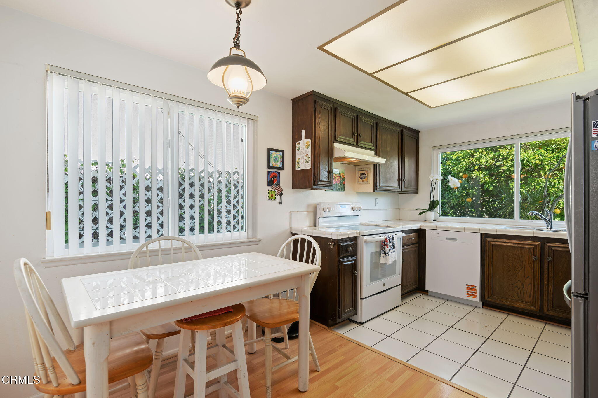 1126 Lawrence Way Oxnard, CA 93035 - Photo 10 of 16 a kitchen with a stove a sink and a refrigerator