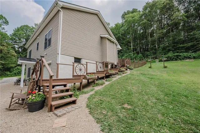 a view of backyard of house with outdoor seating and green space