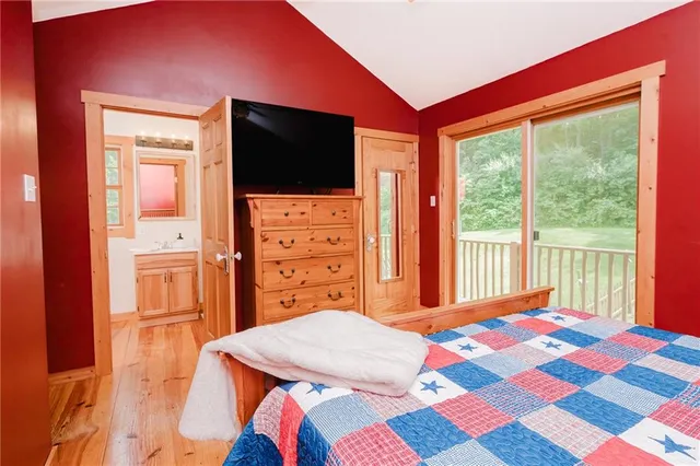 a bedroom with a bed and a flat screen tv