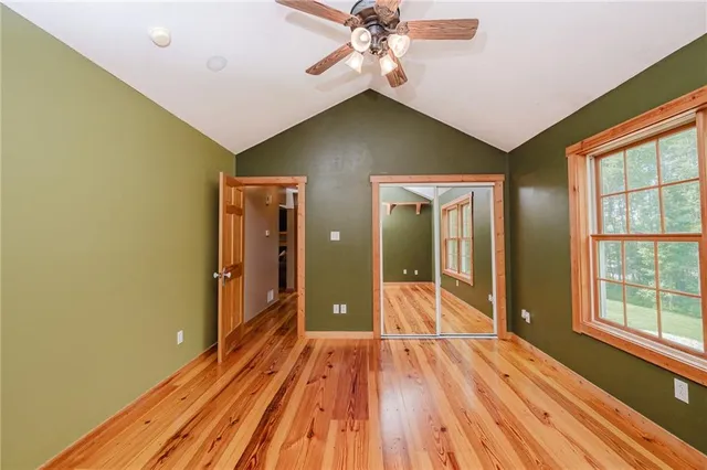 a view of a room with wooden floor and door