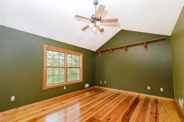 a view of a room with a ceiling fan and a window