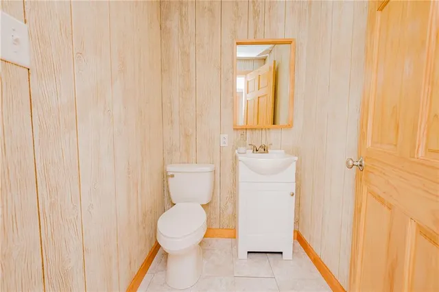 a bathroom with a toilet a sink and a shower curtain