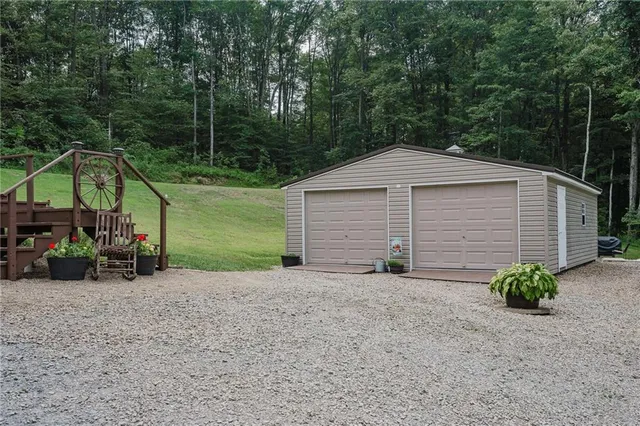 a view of a house with large trees and a small yard