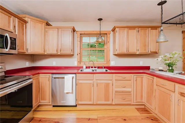 a kitchen with a sink cabinets and window