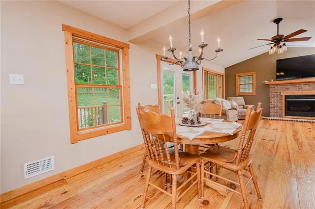 a view of a dining room with furniture a chandelier and wooden floor