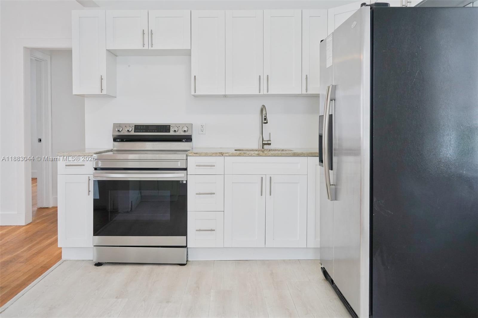 3770 Southwest 27th Street, Unit 3772 Miami, FL 33134 - Photo 5 of 15 a kitchen with cabinets appliances and a sink