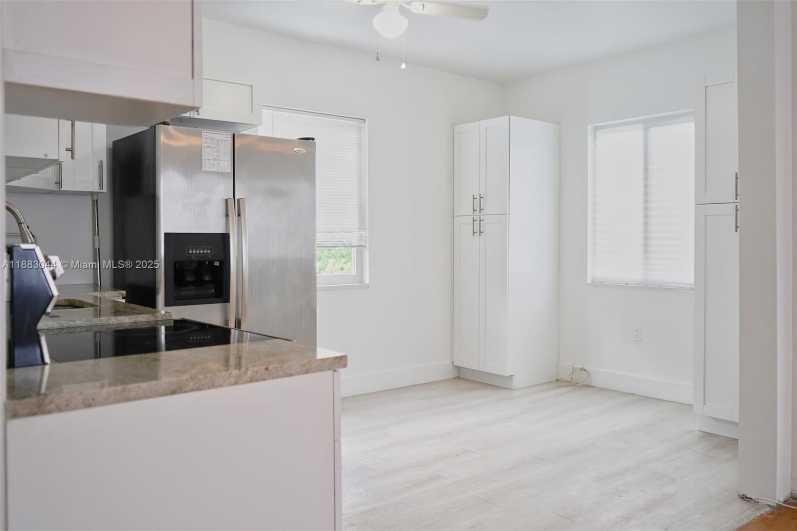 3770 Southwest 27th Street, Unit 3772 Miami, FL 33134 - Photo 6 of 15 a living room with stainless steel appliances kitchen island granite countertop a refrigerator and a sink