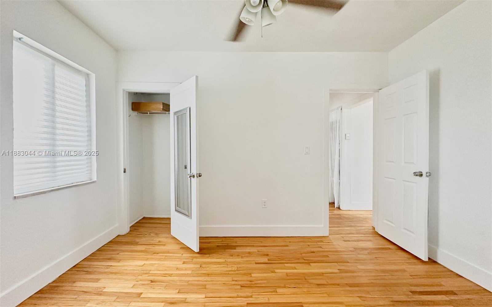 3770 Southwest 27th Street, Unit 3772 Miami, FL 33134 - Photo 7 of 15 a view of an empty room with closet and wooden floor