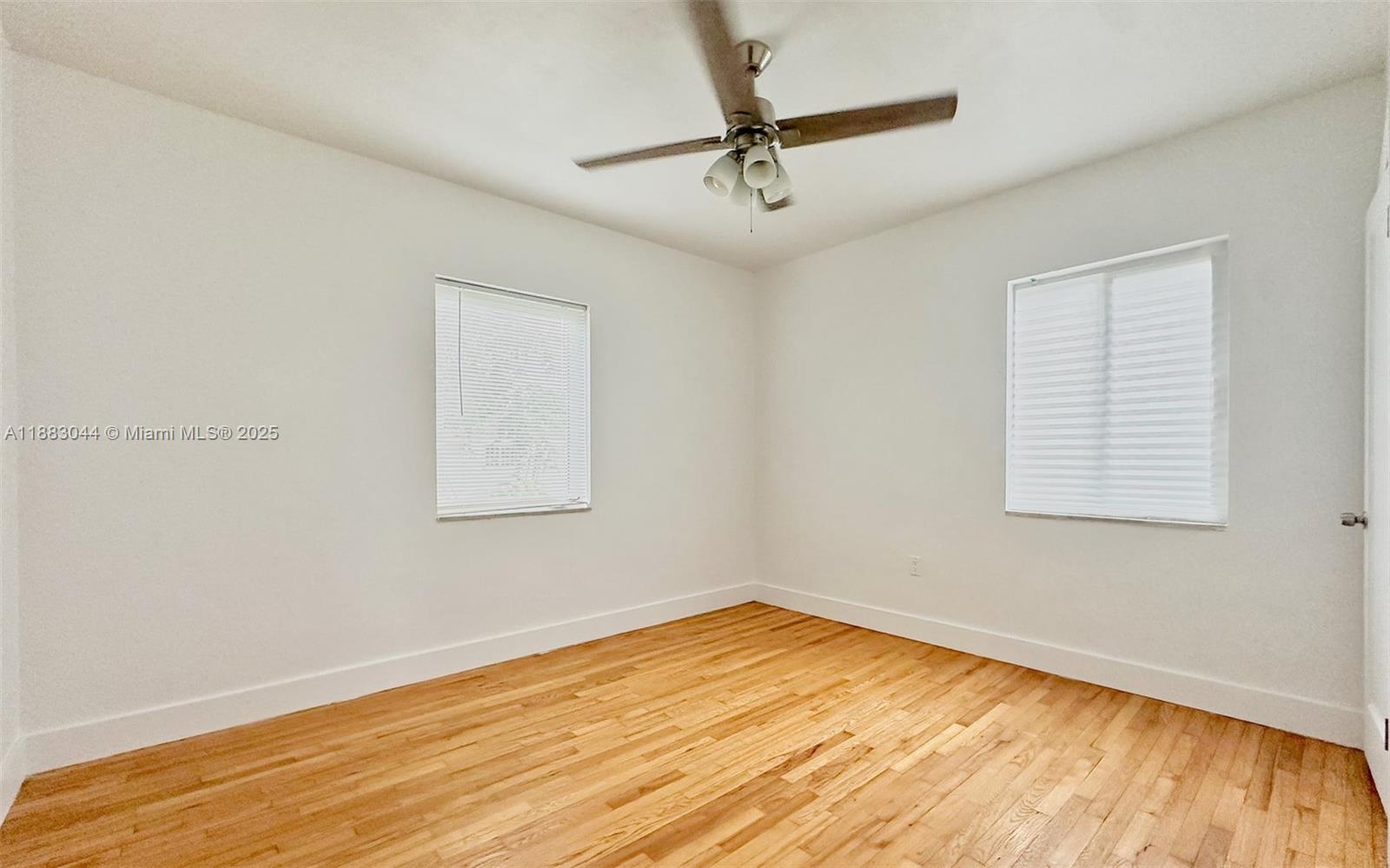 3770 Southwest 27th Street, Unit 3772 Miami, FL 33134 - Photo 8 of 15 a view of empty room with wooden floor and fan