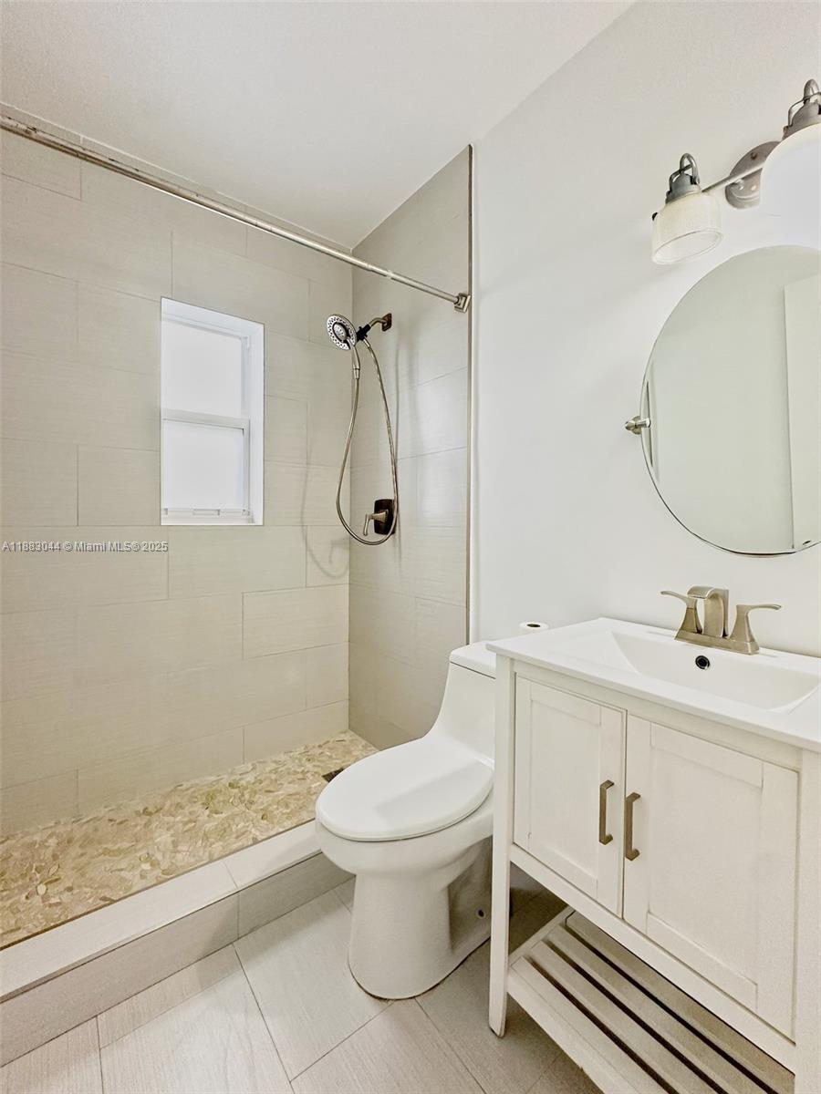 3770 Southwest 27th Street, Unit 3772 Miami, FL 33134 - Photo 10 of 15 a bathroom with a sink a toilet and shower