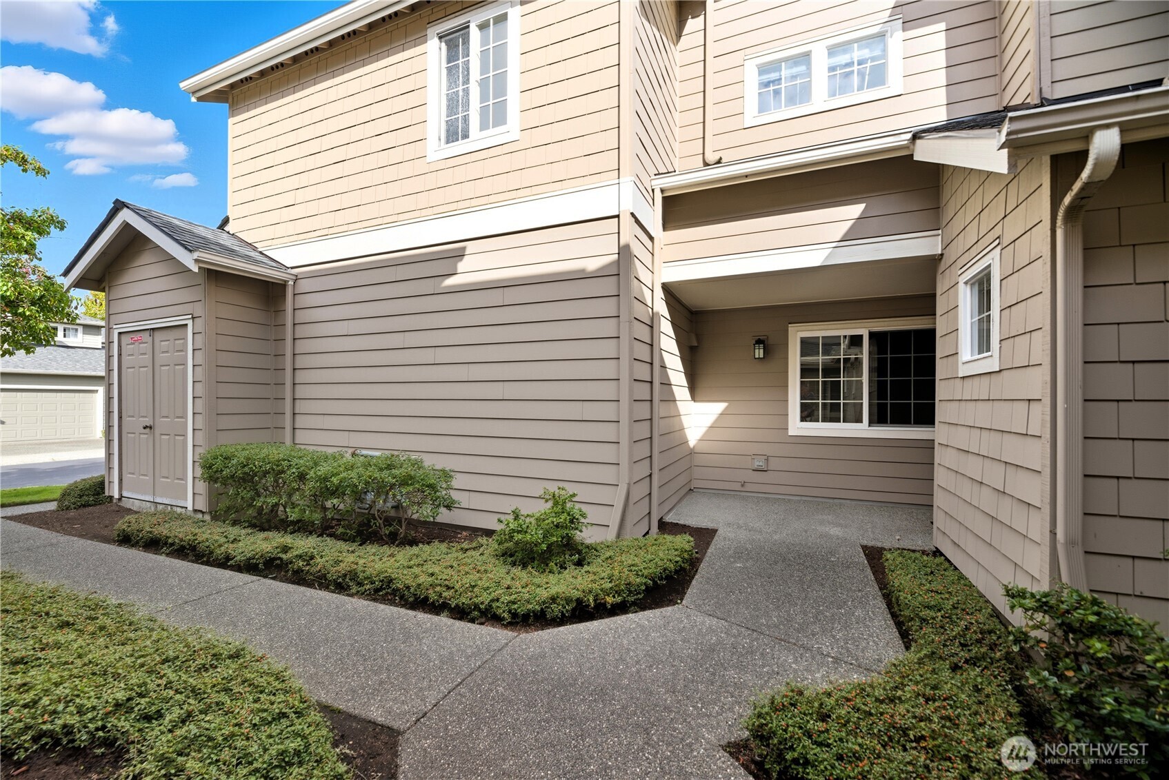 1430 West Casino Road, Unit 272 Everett, WA 98204 - Photo 29 of 37 a view of a white house with a small yard and plants