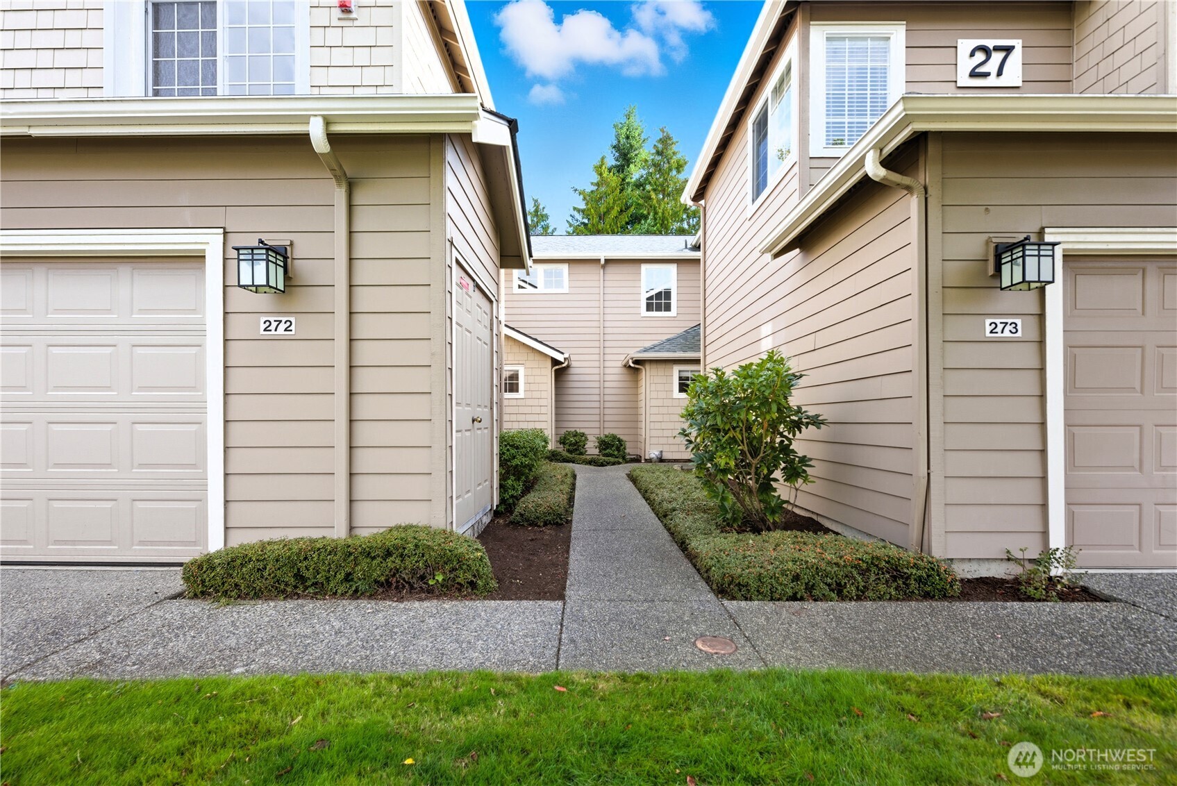 1430 West Casino Road, Unit 272 Everett, WA 98204 - Photo 32 of 37 a view of a white house with a yard and plants