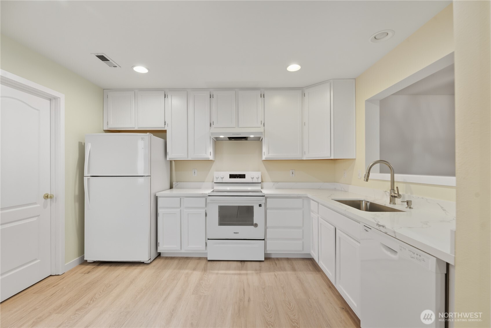 1430 West Casino Road, Unit 272 Everett, WA 98204 - Photo 4 of 37 a kitchen with a sink cabinets stainless steel appliances and a window