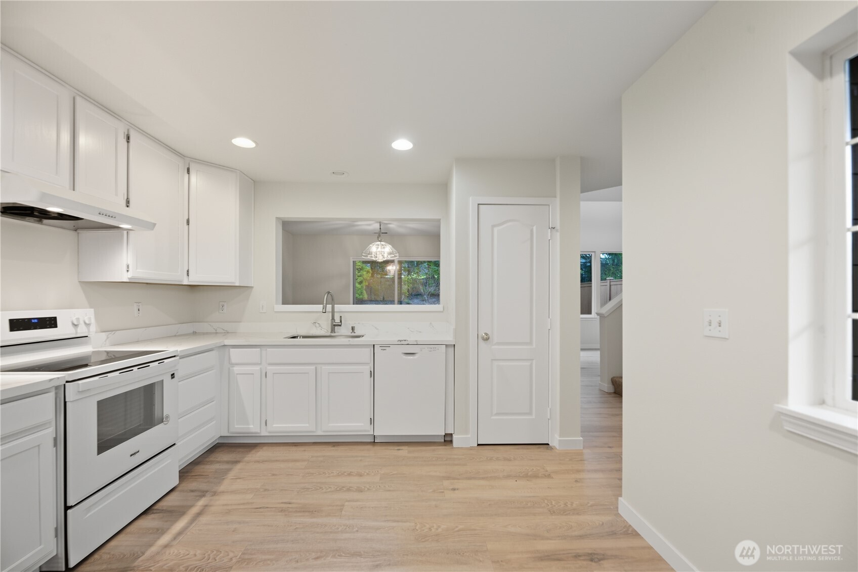 1430 West Casino Road, Unit 272 Everett, WA 98204 - Photo 5 of 37 a large white kitchen with stainless steel appliances granite countertop a stove and a sink