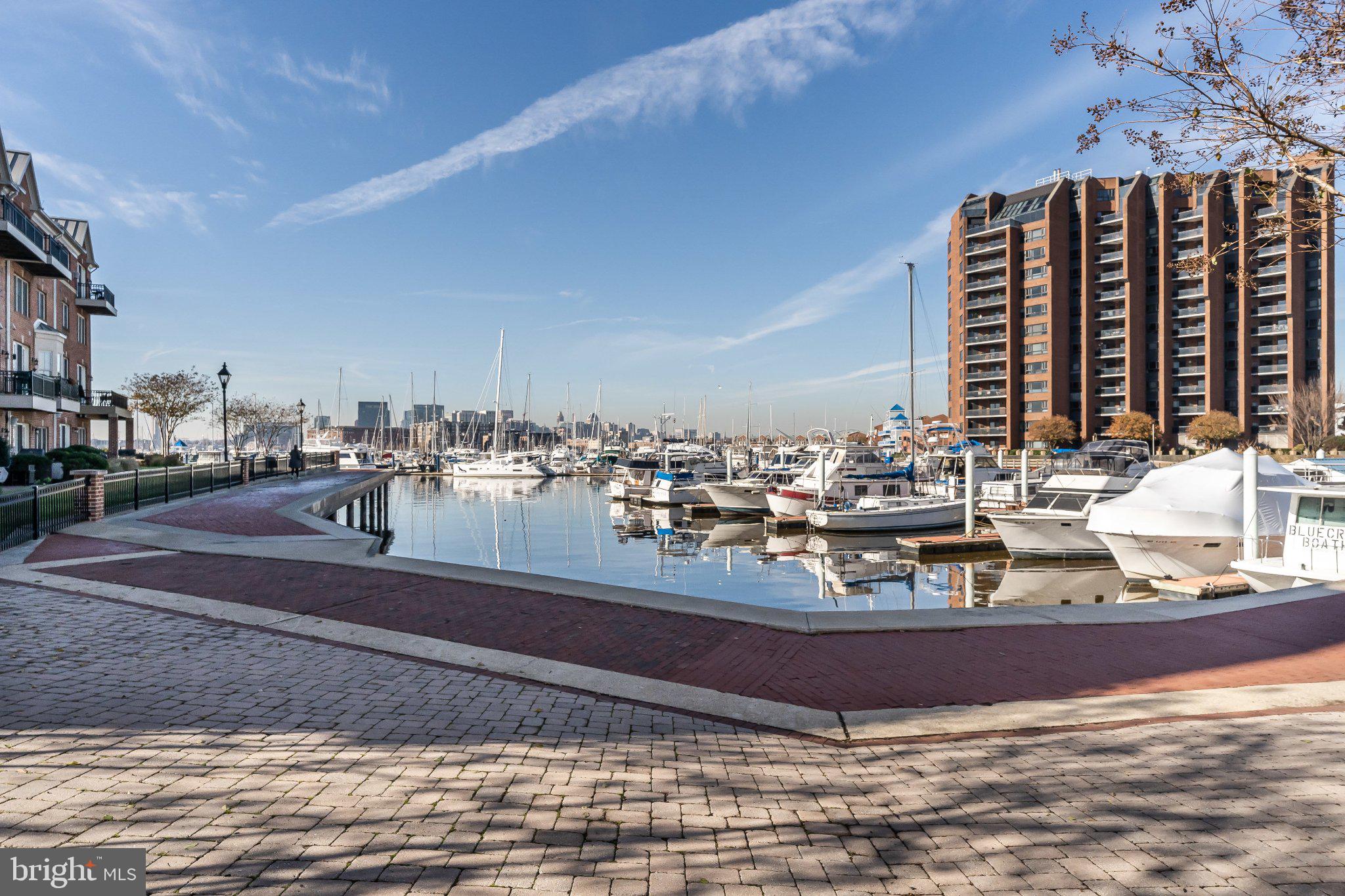 2702 Lighthouse Point East, Unit 532 Baltimore, MD 21224 - Photo 38 of 41 Serene marina with city skyline view.