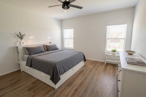 208 Wolf Springs Road Georgetown, TX 78628 - Photo 13 of 32 A well-lit room showcasing rich hardwood flooring and vaulted ceilings.