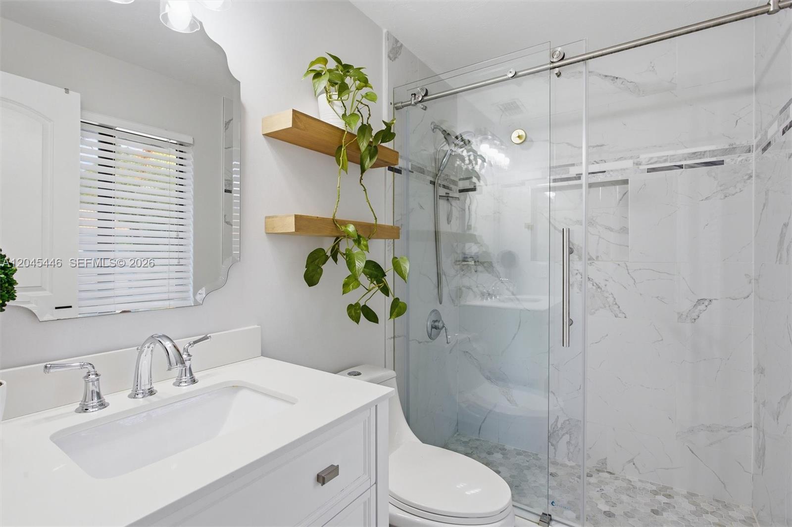8440 Southwest 180th Street Palmetto Bay, FL 33157 - Photo 32 of 54 a bathroom with a sink a toilet and shower
